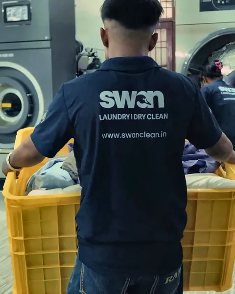 Swan Clean team bringing garments into the laundry plant