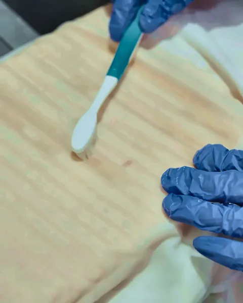 Stain being treated by hand before dry cleaning