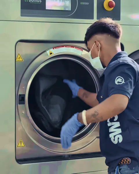 Garments loaded into a professional washer at Swan Clean