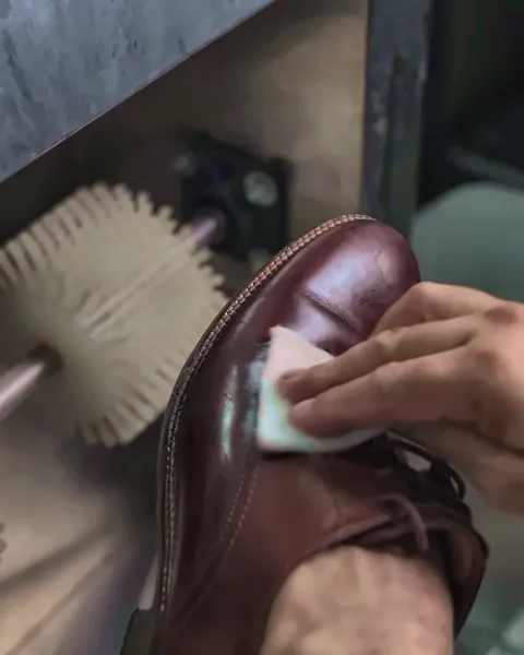 Leather shoe cleaned and conditioned by hand
